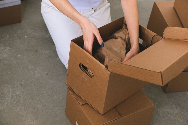 a person packing a box